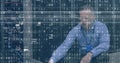 Image of interference and binary coding over caucasian man using laptop in server room Royalty Free Stock Photo