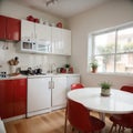 Interior of light kitchen with red fridge white counters and dining table Royalty Free Stock Photo