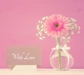 Image of International women day concept with beautiful flower in the vase on wooden table. Royalty Free Stock Photo