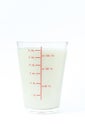 Image of isolated fresh milk in a clear glass containing milligrams for a refreshing drink and a healthy food on a white