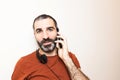 Image of an isolated young white man with beard, doing a call as a part of his job at home Royalty Free Stock Photo