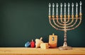 image of jewish holiday Hanukkah with drawing menorah candles (traditional Candelabra), wooden dreidels (spinning top) Royalty Free Stock Photo