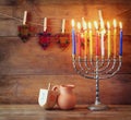 low key image of jewish holiday Hanukkah with menorah (traditional Candelabra) and wooden dreidels (spinning top) Royalty Free Stock Photo