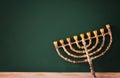 image of jewish holiday Hanukkah with menorah (traditional Candelabra) over chalkboard background, room for text Royalty Free Stock Photo