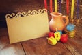 image of jewish holiday Hanukkah with menorah (traditional Candelabra) and wooden dreidels (spinning top) with empty card Royalty Free Stock Photo