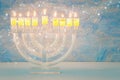 image of jewish holiday Hanukkah background with crystal menorah (traditional candelabra) Royalty Free Stock Photo