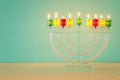 image of jewish holiday Hanukkah background with crystal menorah (traditional candelabra) Royalty Free Stock Photo