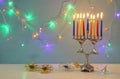 image of jewish holiday Hanukkah background with menorah & x28;traditional candelabra& x29; and burning candles Royalty Free Stock Photo