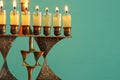 Image of jewish holiday Hanukkah background with menorah & x28;traditional candelabra& x29; and burning candles. Royalty Free Stock Photo