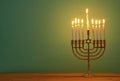 image of jewish holiday Hanukkah background with menorah (traditional candelabra) and candles. Royalty Free Stock Photo