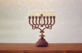 Image of jewish holiday Hanukkah background with menorah & x28;traditional candelabra& x29; and burning candles Royalty Free Stock Photo