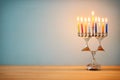 image of jewish holiday Hanukkah background with menorah (traditional candelabra) and burning candles. Royalty Free Stock Photo