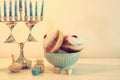 image of jewish holiday Hanukkah background with traditional spinnig top, menorah & x28;traditional candelabra& x29; and donut. Royalty Free Stock Photo