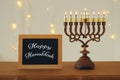Image of jewish holiday Hanukkah background with traditional spinnig top, menorah & x28;traditional candelabra& x29;.