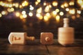 Image of jewish holiday Hanukkah with wooden dreidels colection & x28;spinning top& x29; and glowing gold lights Royalty Free Stock Photo