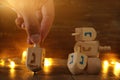 Image of jewish holiday Hanukkah with wooden dreidels colection & x28;spinning top& x29; and gold garland lights Royalty Free Stock Photo