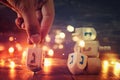 Image of jewish holiday Hanukkah with wooden dreidels colection & x28;spinning top& x29; and gold garland lights Royalty Free Stock Photo