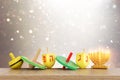 Image of jewish holiday Hanukkah with wooden dreidels collection (spinning top) over glitter background Royalty Free Stock Photo