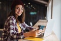 Image of joyful caucasian girl using laptop and cellphone