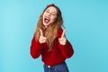 Image of joyful caucasian woman laughing and pointing fingers at camera Royalty Free Stock Photo