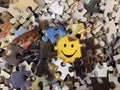 The image of a joyful face on cardboard. Puzzle in detail in a mosaic set. Concept: joy, happiness, positive, kindness