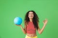 Image of joyful woman 20s wearing summer clothes smiling and holding volley ball Royalty Free Stock Photo