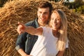 Image of joyous couple man and woman walking on golden field aft