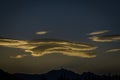 Unique feathery clouds drifting over the mountains at sunrise in Banff Alberta.