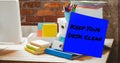 Image of keep your desk clean text on memo note over stationery items on desk Royalty Free Stock Photo