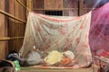 Image of a Khmer rural people in the countryside inside of a mosquito net. Resting, sleeping.