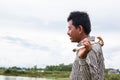 Image of lake in Asia , man portrait. Fisherman in lake. Traditional countryside  in rural part of Cambodia Royalty Free Stock Photo