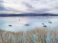 Boats on Lake Benmore with snow cupped Southern Alps mountains