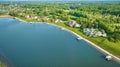 Lakeside mansion properties aerial with boat docks and forested skyline