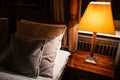 Lamp on a night table next to a bed Royalty Free Stock Photo
