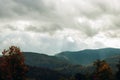 Image of a landscape overlooking mountain forests. The rays of the sun illuminate the forest land. Clouds covered the sky. Travel Royalty Free Stock Photo