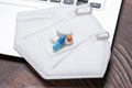 Image of a laptop and a protective medical mask with pills. Concept of online consultation with a doctor. Self-medication,