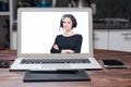Image of a laptop with a splash screen that depicts a woman with headsets. Customer support concept Royalty Free Stock Photo