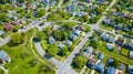 Large aerial neighborhood in summertime with large green trees in city two-story houses