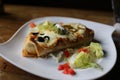 Large Burrito on a white plate Royalty Free Stock Photo