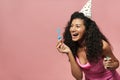 Image of laughing african american woman making soap bubbles