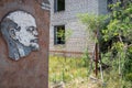 Image of Lenin in the exclusion zone of Belarus against the background of an abandoned building.