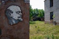 Image of Lenin in the exclusion zone of Belarus against the background of an abandoned building.