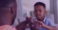 Image of letters floating over happy african american father and son playing finger games