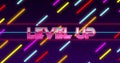 Image of level up text banner over colorful light trails against blue background Royalty Free Stock Photo