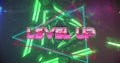 Image of level up text over neon pattern background Royalty Free Stock Photo