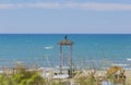 Image of a lifeguard tower photographed through the vegetation w