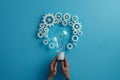 An image of a light bulb with white gears around it, isolated on a blue background. SEO technology concept. Copy space Royalty Free Stock Photo