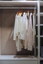 Light colored shirts hanging in the closet