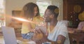 Image of light and dots moving over happy african american father and daughter using tablet Royalty Free Stock Photo