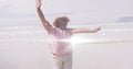 Image of light spots over happy senior african american woman dancing on sunny beach Royalty Free Stock Photo